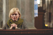 Young woman praying in a church