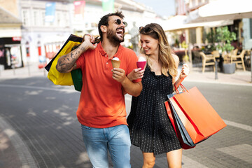 Wall Mural - beautiful young loving couple walking by the street while shopping and traveling