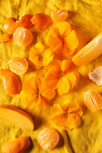 Orange Primroses And Fruits On The Orange Linen Fabric