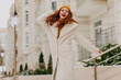 © Look! - Gorgeous girl with pretty smile posing in winter. Outdoor photo of romantic ginger lady in white coat.