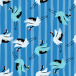 Bright random cartoon seamless pattern with white and blue crane shapes. Striped background.