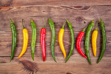 Fototapeta Do akwarium - Small peppers on a wooden background. View from another angle in the portfolio.