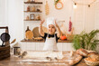 happy little boy in chef hat and apron is playing with flour for text on a wooden kitchen