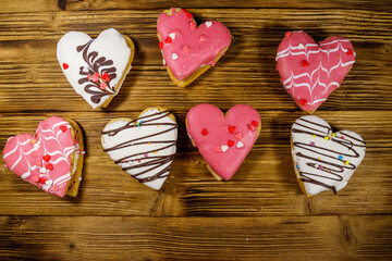 Wall Mural - Heart shaped cookies on wooden table. Top view. Dessert for Valentine day