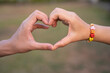 © MERCURY studio - Couple holding hands with hand string of LOVE word in blur background, Happy Women's, Mother's, Valentine's Day concept.