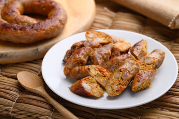 Wall Mural - Northern Thai sausage (Sai Aua), Grilled intestine stuffed with minced pork, spices and herbs, popular food in Chiangmai, Thailand