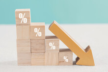 Wooden Blocks With Percentage Sign And Down Arrow, Financial Recession Crisis, Interest Rate Fall, Investment Reduce, Risk Management Concept