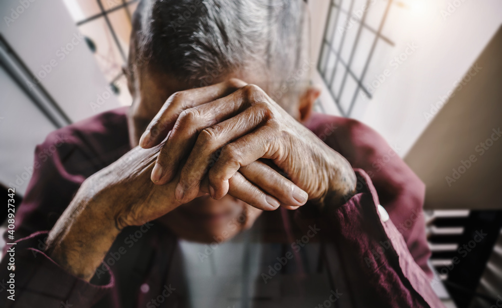 senior man covering his face with his hands. Stock Photo | Adobe Stock