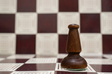 Wall Mural - Close-up shot of a black wooden Bishop on the chess board