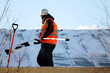 Worker removing snow on the roof of a building. Snow removal, climber cleaning roof in winter