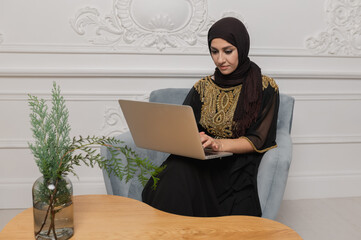 Arab businessman working on laptop computer at home