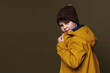 © Red Cristal - Portrait of young boy posing in studio on green background. Casual style. Stylish shooting in studio