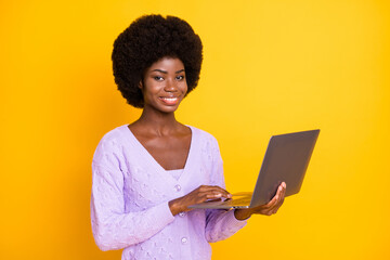 Sticker - Portrait of pretty dark skin lady hold use laptop look camera toothy smile isolated on yellow color background