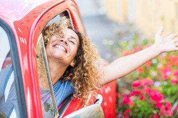 Wall Mural - Young woman enjoy drive the car and travel - happy people female dricing vehicle and having fun - concept of female and automobile - free person traveling and laughing