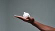 Close up of hand of young african american man holding shaving foam, ready to shave isolated over gray background