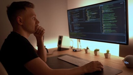 Modern concentrated young man typing on keyboard, work from home at night. working remotely, Software Development, Code Writing, Website Design, Database Architecture concept