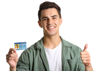 Wall Mural - Young man with driving license on white background