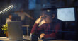 © TommyStockProject - Young businessman having headache working overtime on laptop in office late night