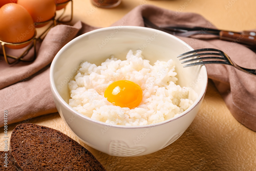 Bowl with tasty egg and rice on color background