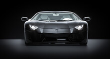 Black Sports Car On Carbon Fiber Background.