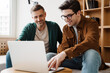 © Drobot Dean - Happy young gay couple using laptop computer