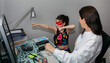 © David Pereiras - Woman teleworking and looking to her daughter in disguise. Selective focus on girl in background