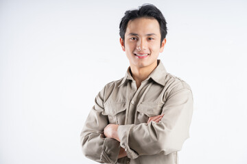 Wall Mural - Portrait of male mechanic standing with arms crossed confidently looking at camera