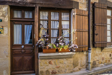 Wall Mural - Cute townhouse facade in the small medieval village of Herisson, situated in Auvergne (France)