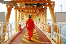 Offshore Oil And Gas Industry And Operated By Technician Petroleum. Worker Walking To Oil And Gas Plant For Work As Routine Plan. Maintenance And Operation Work Scope In Oil And Gas Plant.