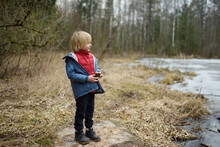 Little Boy Playing On Shore Of Forest Lake On Early Spring Day. Outdoor Activity For Kids.