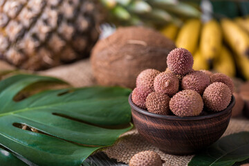 Wall Mural - fresh organic lychee fruit on bamboo basket and old wood background, Blurred background selective focus