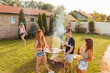 © Impact Photography - Friends having fun at backyard barbecue party