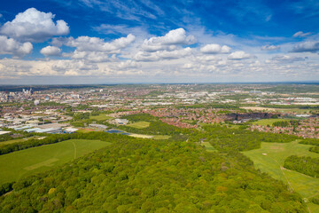 Wall Mural - Aerial photo of the city of Leeds viewed from the village of Middleton and Middleton Park on a sunny day with white clouds in the sky and a lot of green trees in the summer time