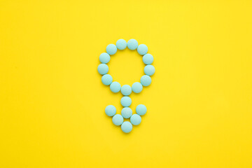 Wall Mural - Male sign made of blue pills on yellow background, flat lay. Potency problems