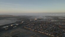 Sunrise Wide Angle Drone Footage Over The Central Valley Of California Looking Towards Sacramento And The Bay Area, USA With Low Lying Mist Rolling In, Pastel Skies And Mountains In The Distance
