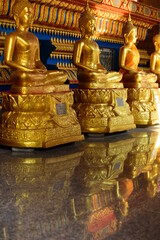 Wall Mural - The golden Buddha image. Reverence in Buddhist sutras At Wat Luang Pothit, Thailand