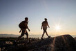© Cavan Images - Two hikers reach summit of mountain in Maine at sunrise