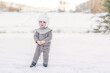 © Cavan Images - Adorable child standing in snow at farm wearing wool knitted clothes