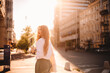 © Cavan Images - Happy young woman standing on street in city during summer