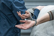 © vadimalekcandr - handcuffs on the prisoner. Making an arrest. The convoy