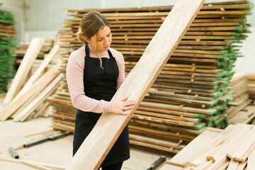 Wall Mural - Pretty worker looking for splinters in a wood bar