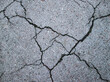 Spoiled asphalt. Photo of an old road with cracks. Destruction texture.
