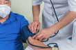 © Alfredo Hernández - Senior man on medical check-up checking blood pressure