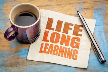 lifelong learning concept -  word abstract on a napkin with a cup of espresso coffee, education, lifestyle and personal development
