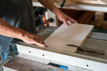 texture of color wood dust sparks over the table, view in the carpenter workshop.