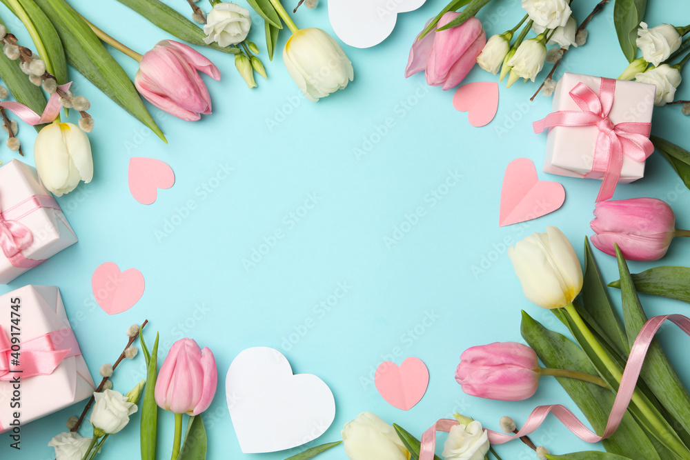 8 march concept with different flowers and gift boxes on blue background, space for text - obrazy, fototapety, plakaty 