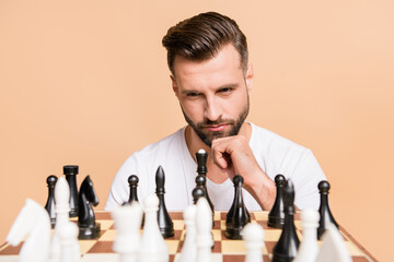 Sticker - Portrait of nice minded guy playing chess overthinking deciding next move isolated over beige pastel color background