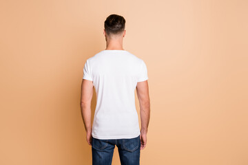 Wall Mural - Back rear view photo of young brown hair man avoiding incognito anonym isolated over beige color background