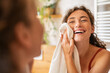 © Rido - Happy woman wiping face with towel in bathroom