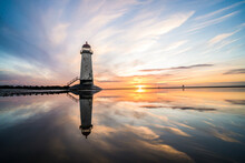 Lighthouse Standing In Pool Of Water Stunning Sunset Sunrise Reflection Reflected In Water And Sea Steps Up To Building North Wales Seashore Sand Beach Still Water Orange Glow Golden Hour Blue Hour